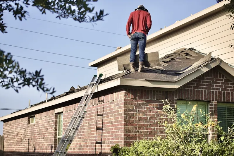 Professional roofer working on a residential roof in Marlton